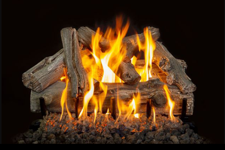 Fireplace with burning logs and flames on a black background