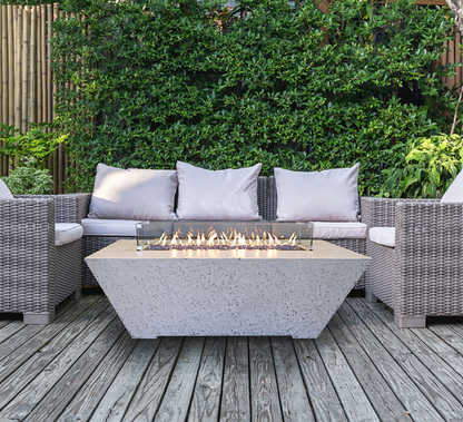 Outdoor patio setting with wicker furniture and a fire pit table.