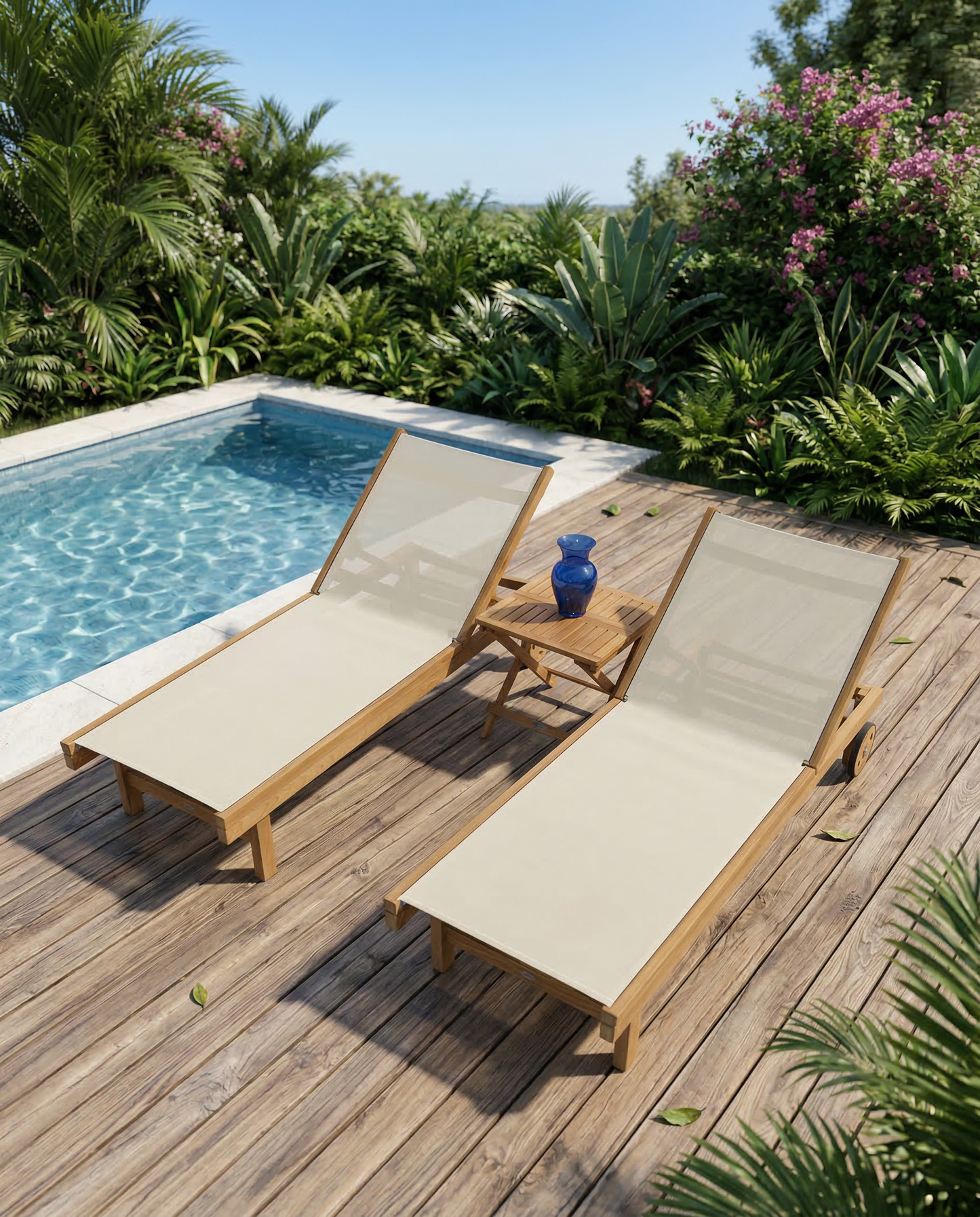 Two wooden lounge chairs with beige cushions on a wooden deck by a pool, surrounded by greenery.
