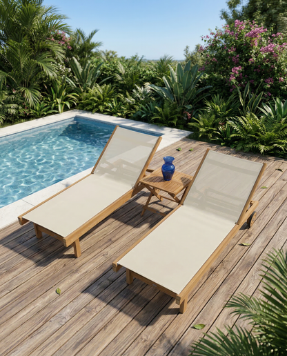 Two wooden lounge chairs with beige cushions on a wooden deck by a pool, surrounded by greenery.