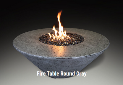 Round gray fire table with flames on a dark background