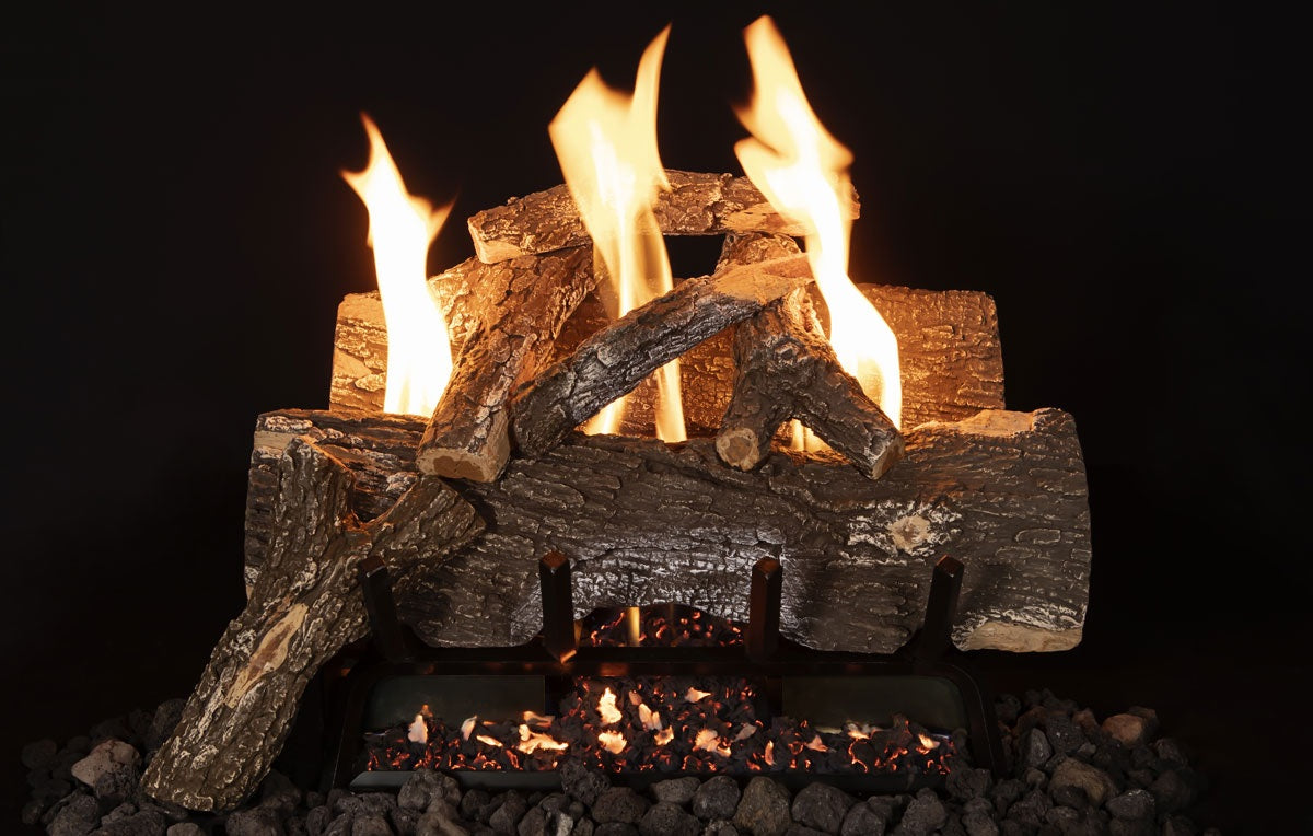 Wooden logs burning in a fireplace with flames against a black background